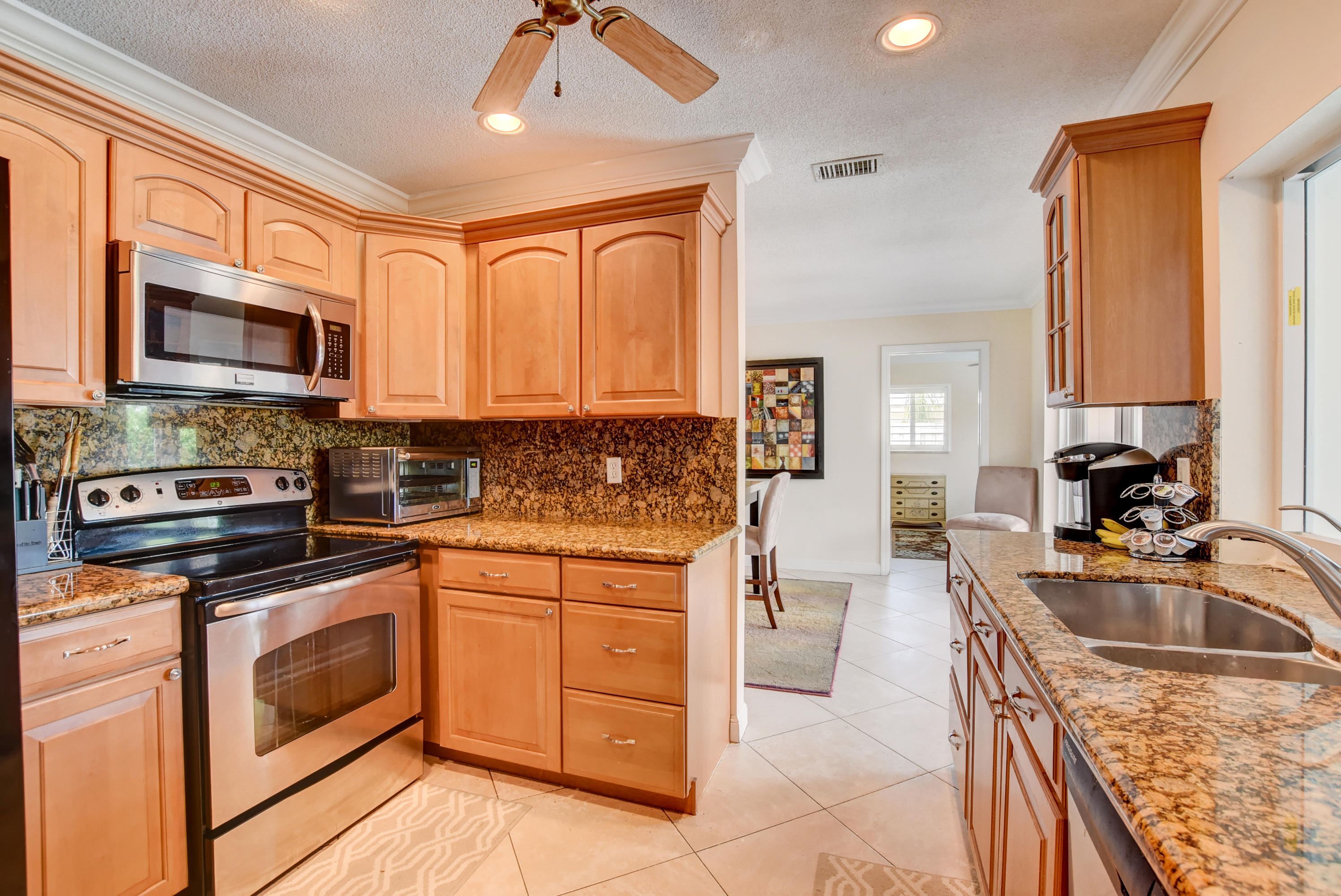 1366 Southwest 13th Place Boca Raton, FL 33486 - Photo 14 of 35 a kitchen with a sink stove top oven and microwave
