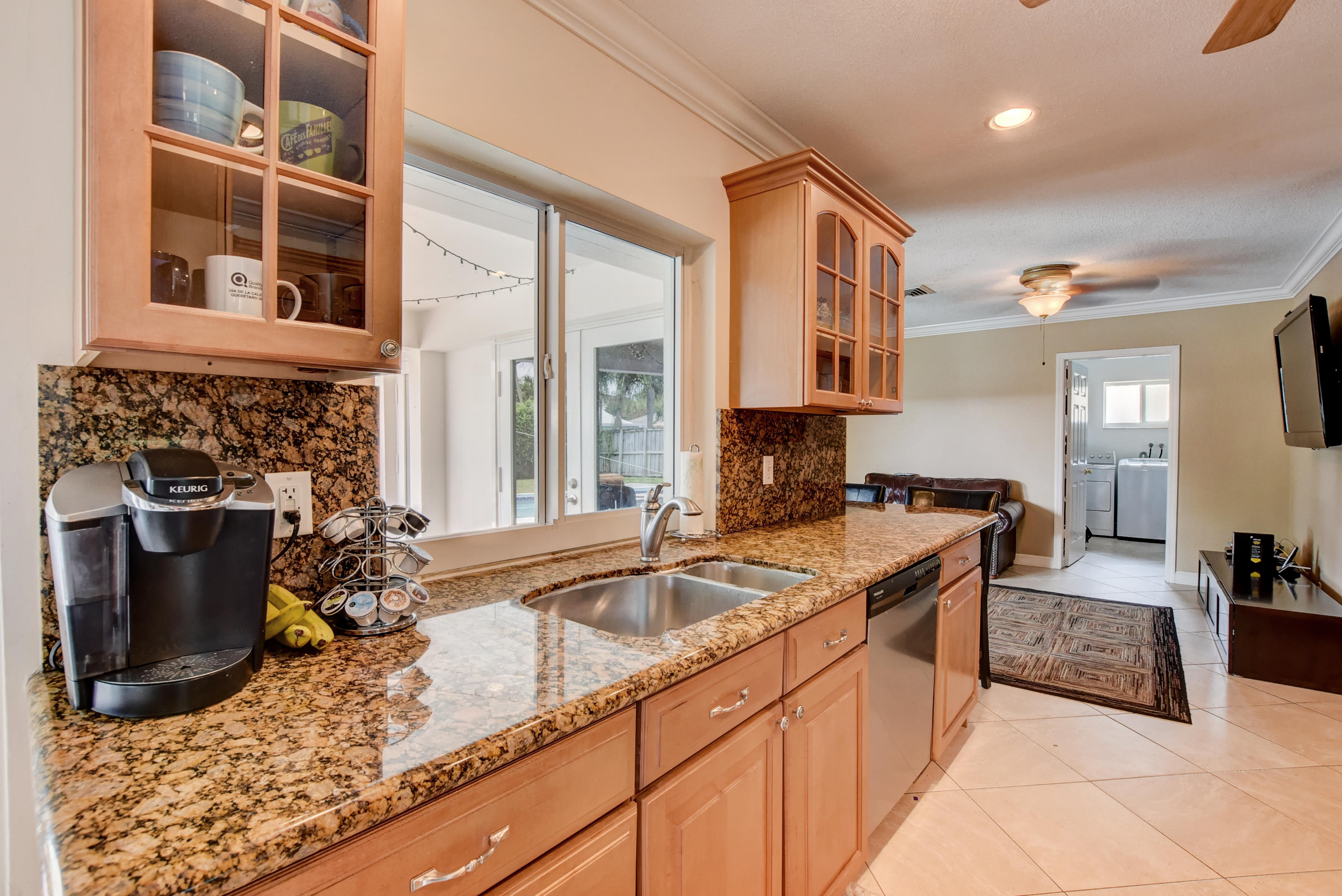 1366 Southwest 13th Place Boca Raton, FL 33486 - Photo 15 of 35 a kitchen with a sink stove and cabinets