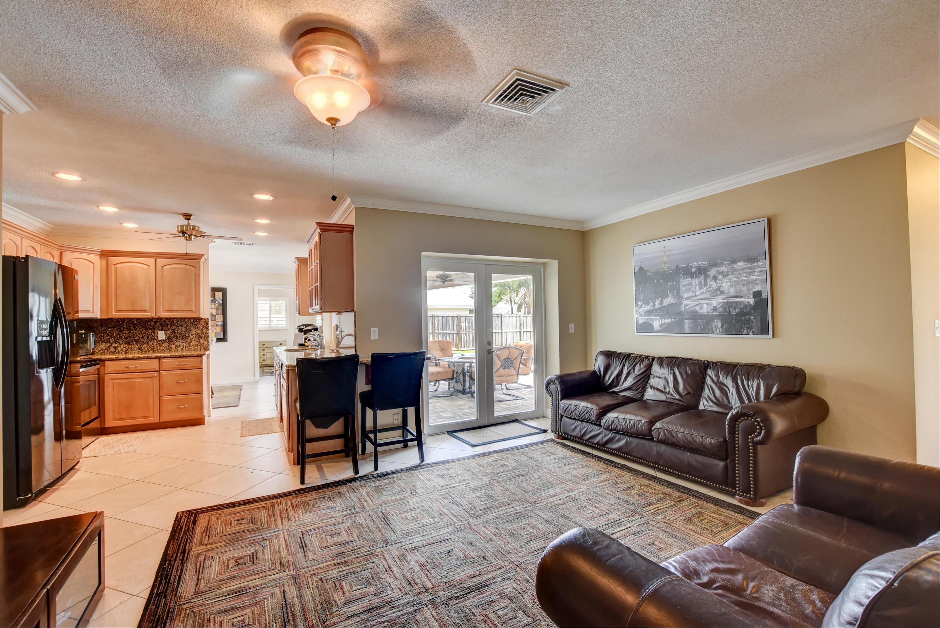 1366 Southwest 13th Place Boca Raton, FL 33486 - Photo 16 of 35 a living room with furniture kitchen view and a chandelier