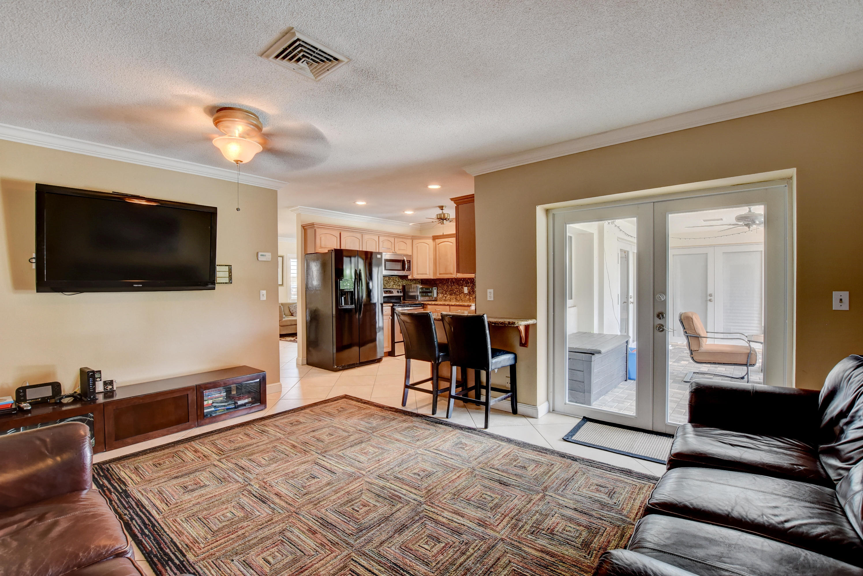 1366 Southwest 13th Place Boca Raton, FL 33486 - Photo 17 of 35 a living room with furniture and a flat screen tv