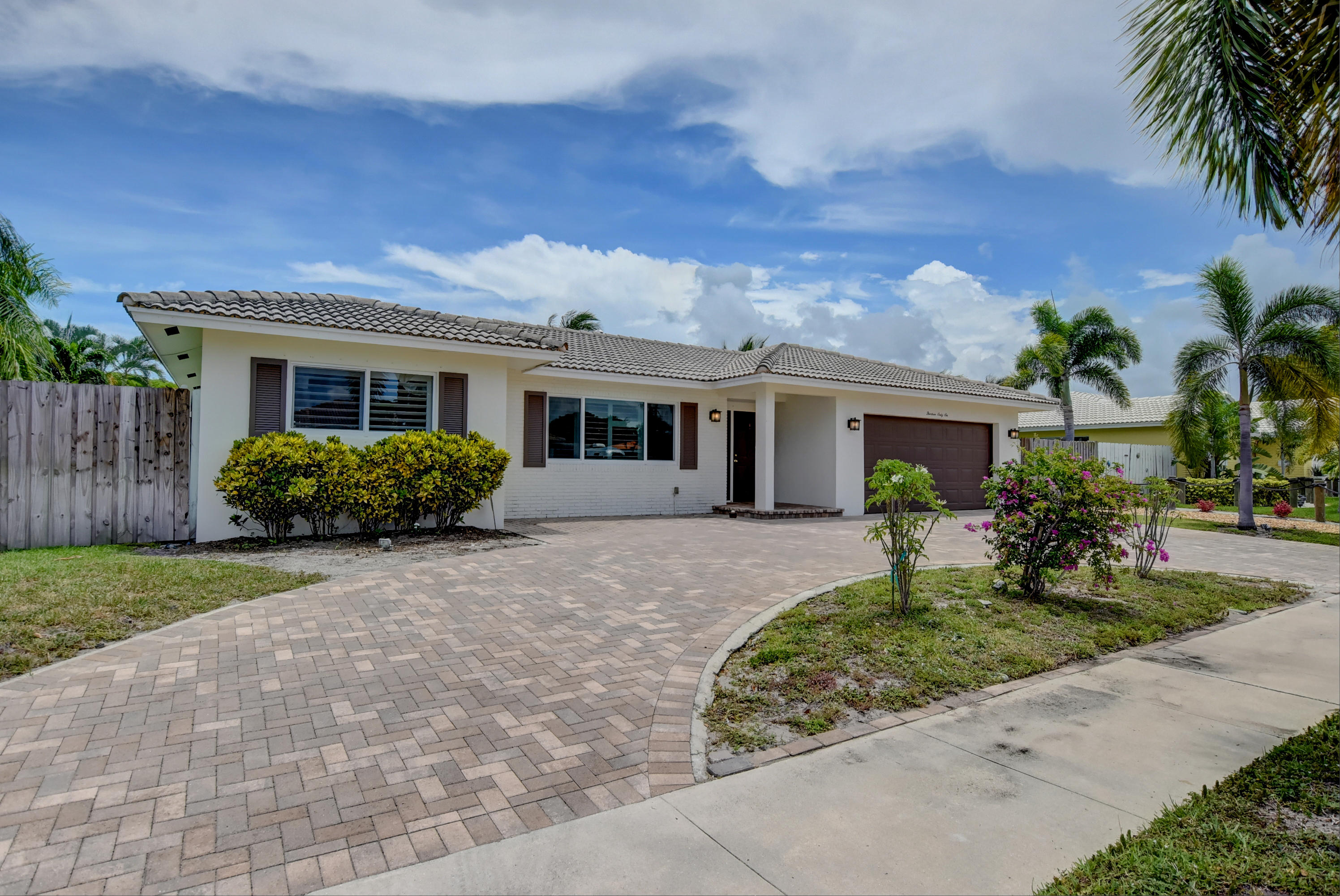 1366 Southwest 13th Place Boca Raton, FL 33486 - Photo 2 of 35 a front view of a house with a garden