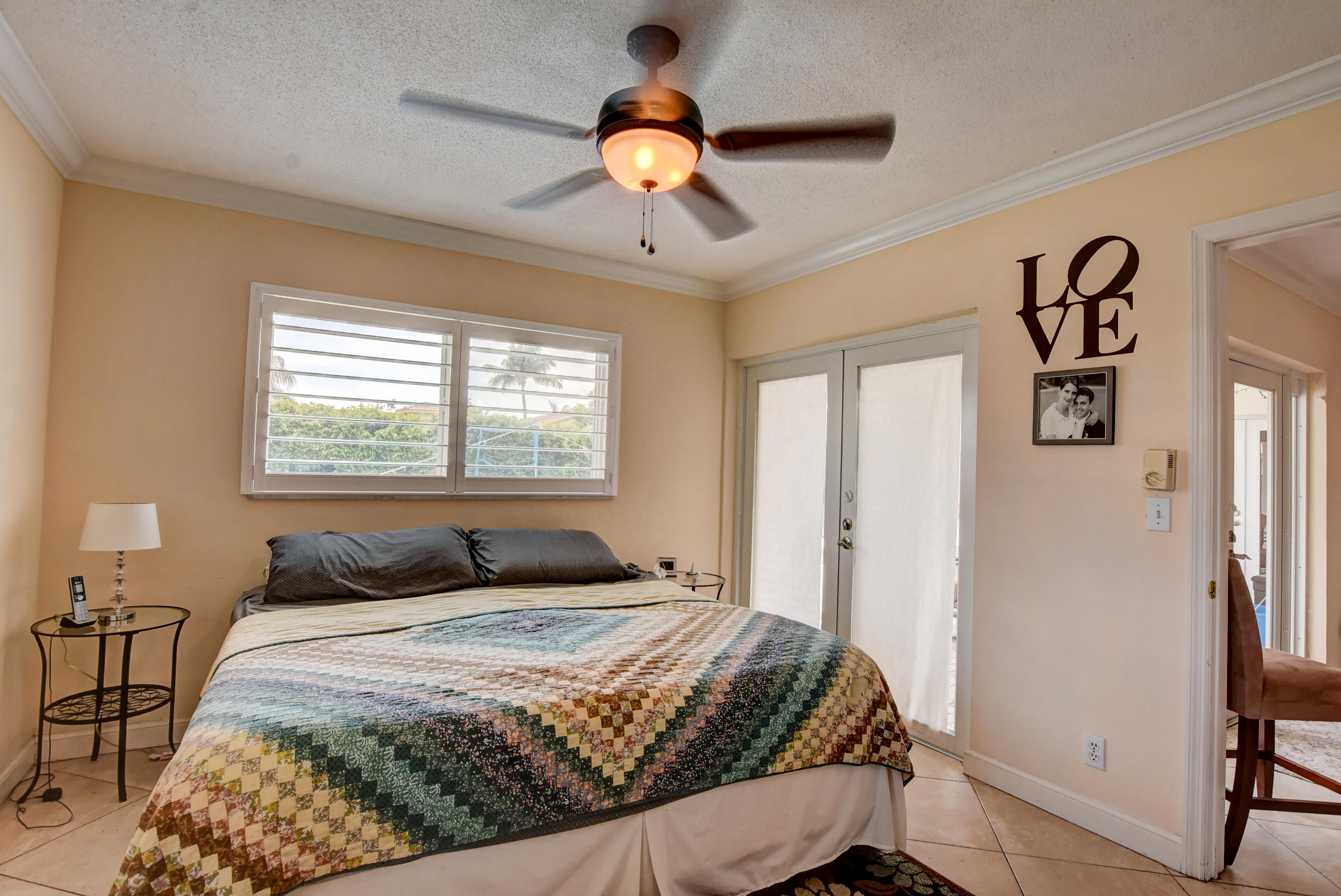 1366 Southwest 13th Place Boca Raton, FL 33486 - Photo 21 of 35 a bedroom with a large bed and a window
