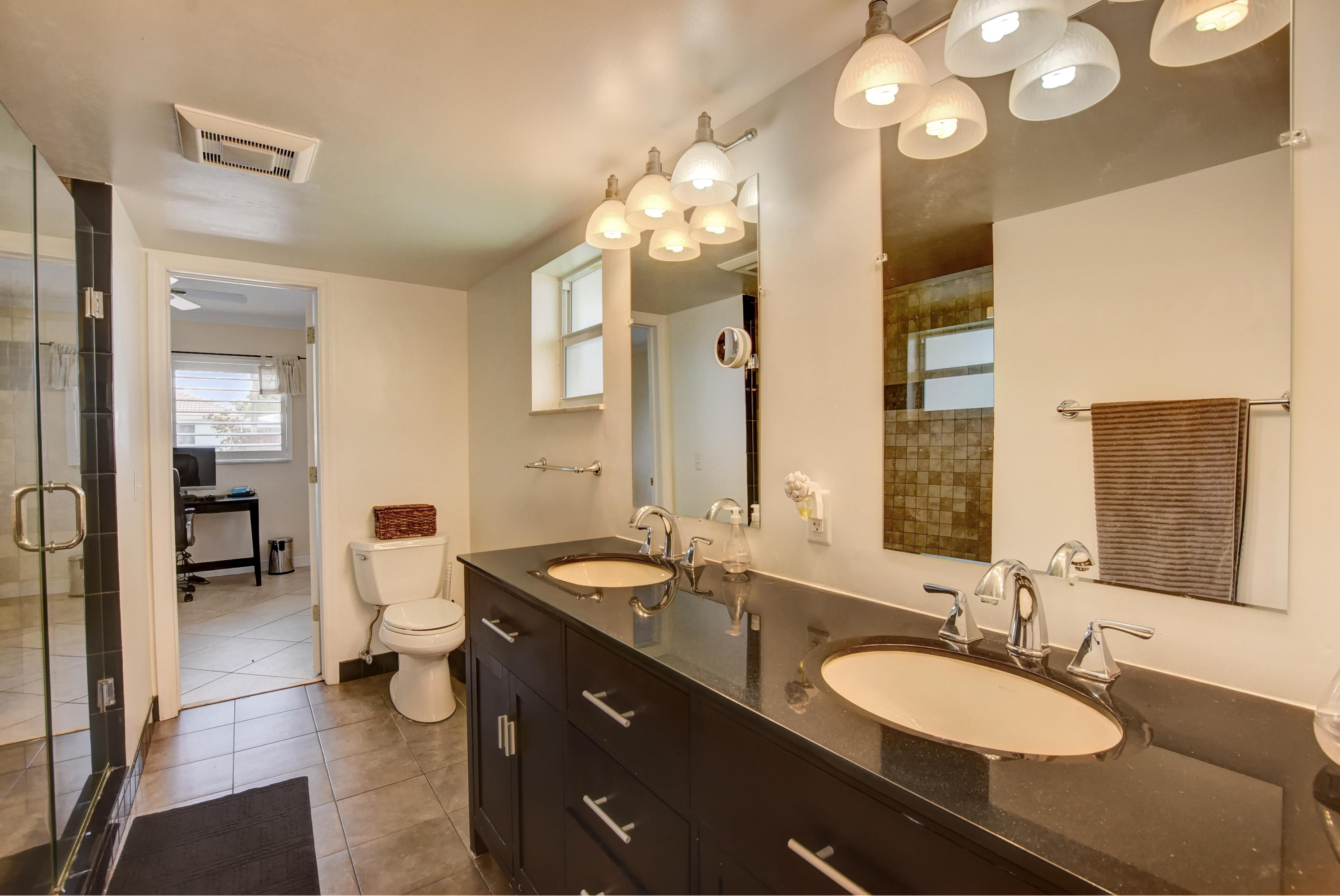 1366 Southwest 13th Place Boca Raton, FL 33486 - Photo 22 of 35 a bathroom with a double vanity sink and a mirror