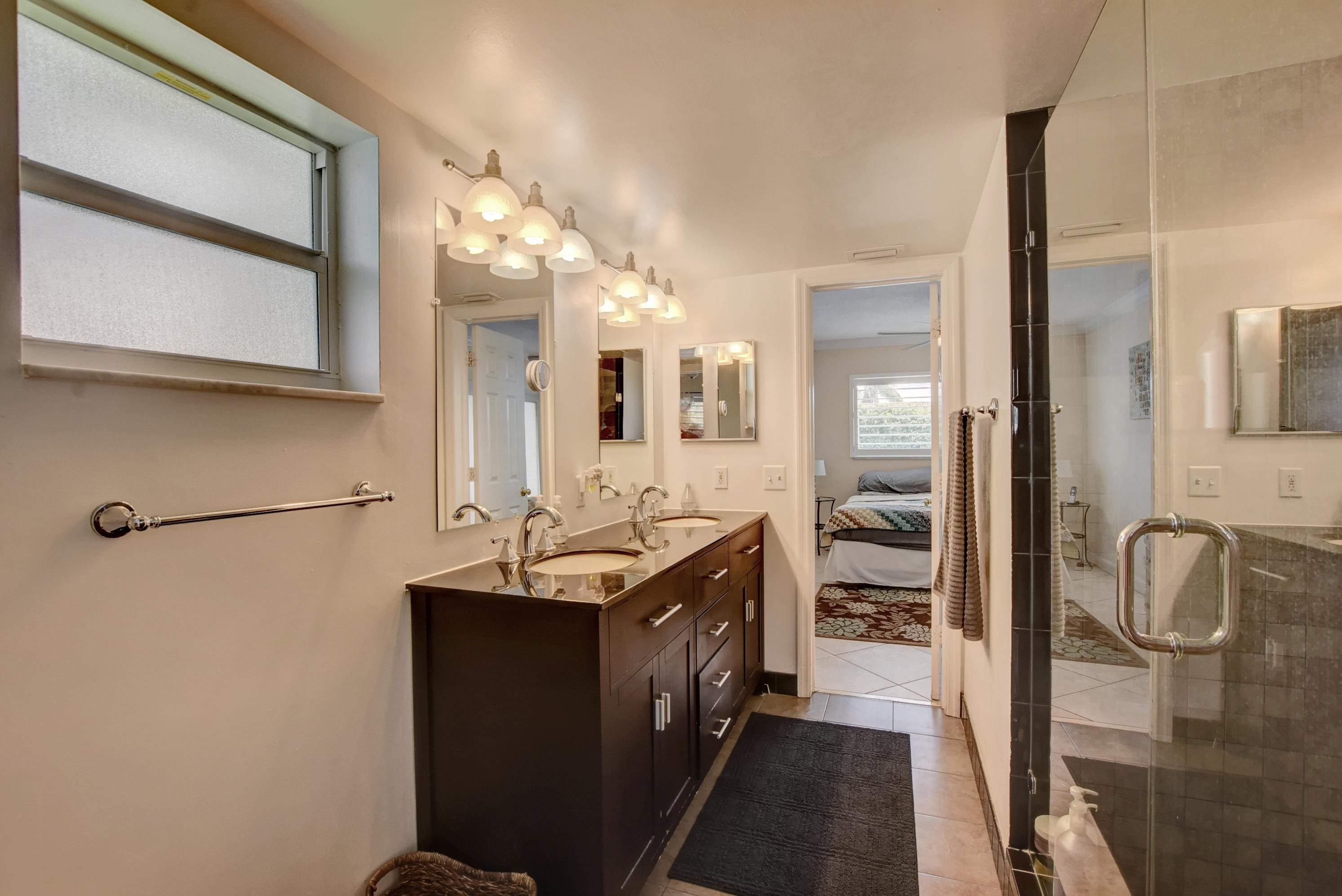 1366 Southwest 13th Place Boca Raton, FL 33486 - Photo 23 of 35 a en suite bathroom with a sink and a mirror