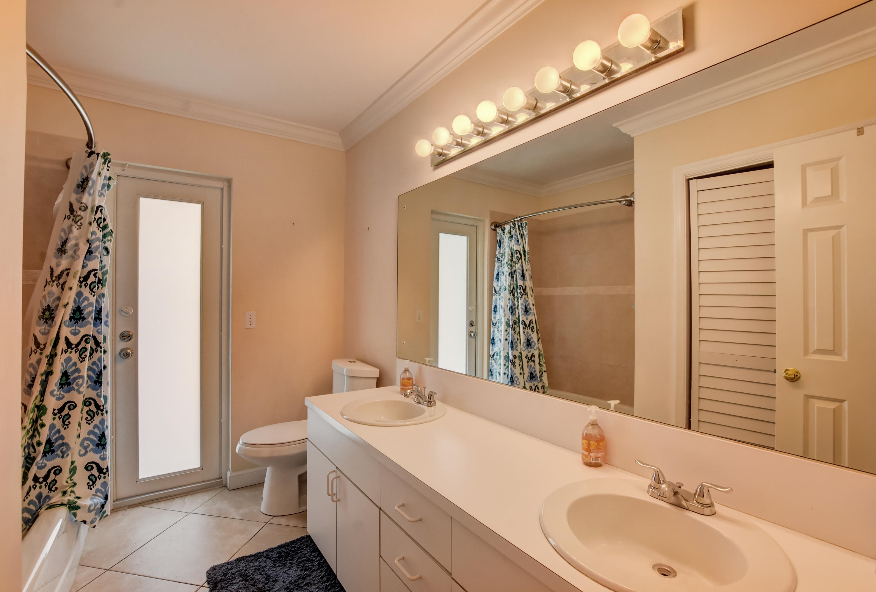 1366 Southwest 13th Place Boca Raton, FL 33486 - Photo 27 of 35 a bathroom with a sink and a mirror