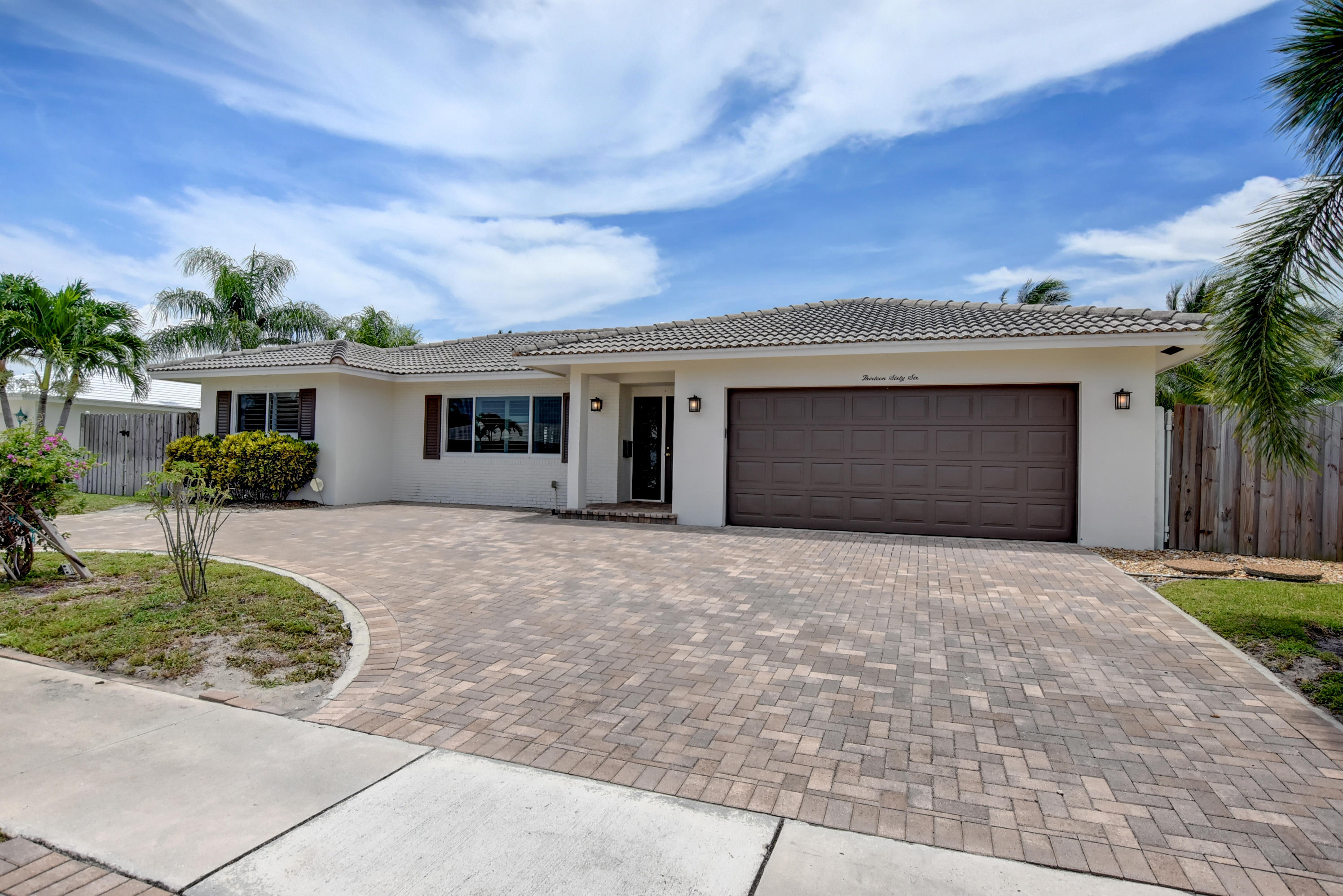 1366 Southwest 13th Place Boca Raton, FL 33486 - Photo 3 of 35 a front view of a house with a yard and garage