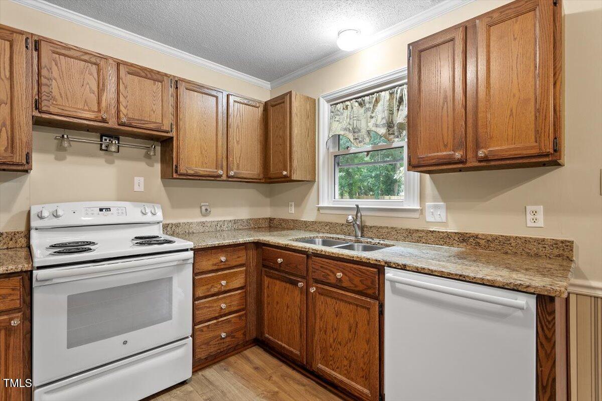 4616 Draper Road Raleigh, NC 27616 - Photo 11 of 34 a kitchen with a sink stove and cabinets