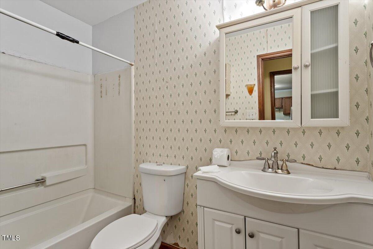4616 Draper Road Raleigh, NC 27616 - Photo 13 of 34 a bathroom with a sink toilet and mirror