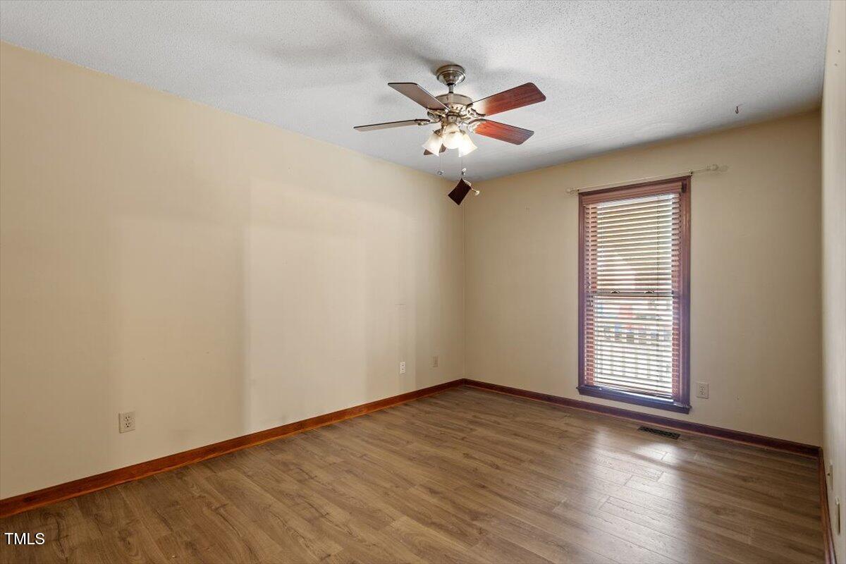 4616 Draper Road Raleigh, NC 27616 - Photo 16 of 34 a view of an empty room with wooden floor and a window