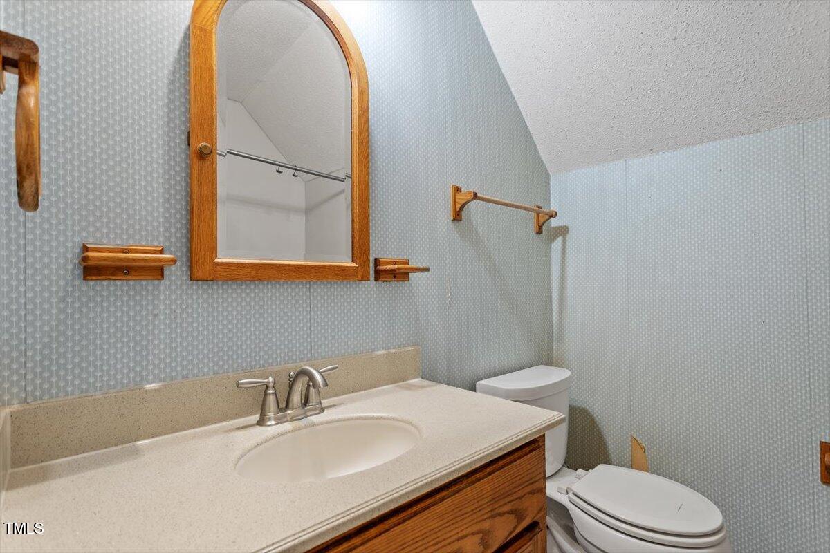 4616 Draper Road Raleigh, NC 27616 - Photo 22 of 34 a bathroom with a sink toilet and mirror