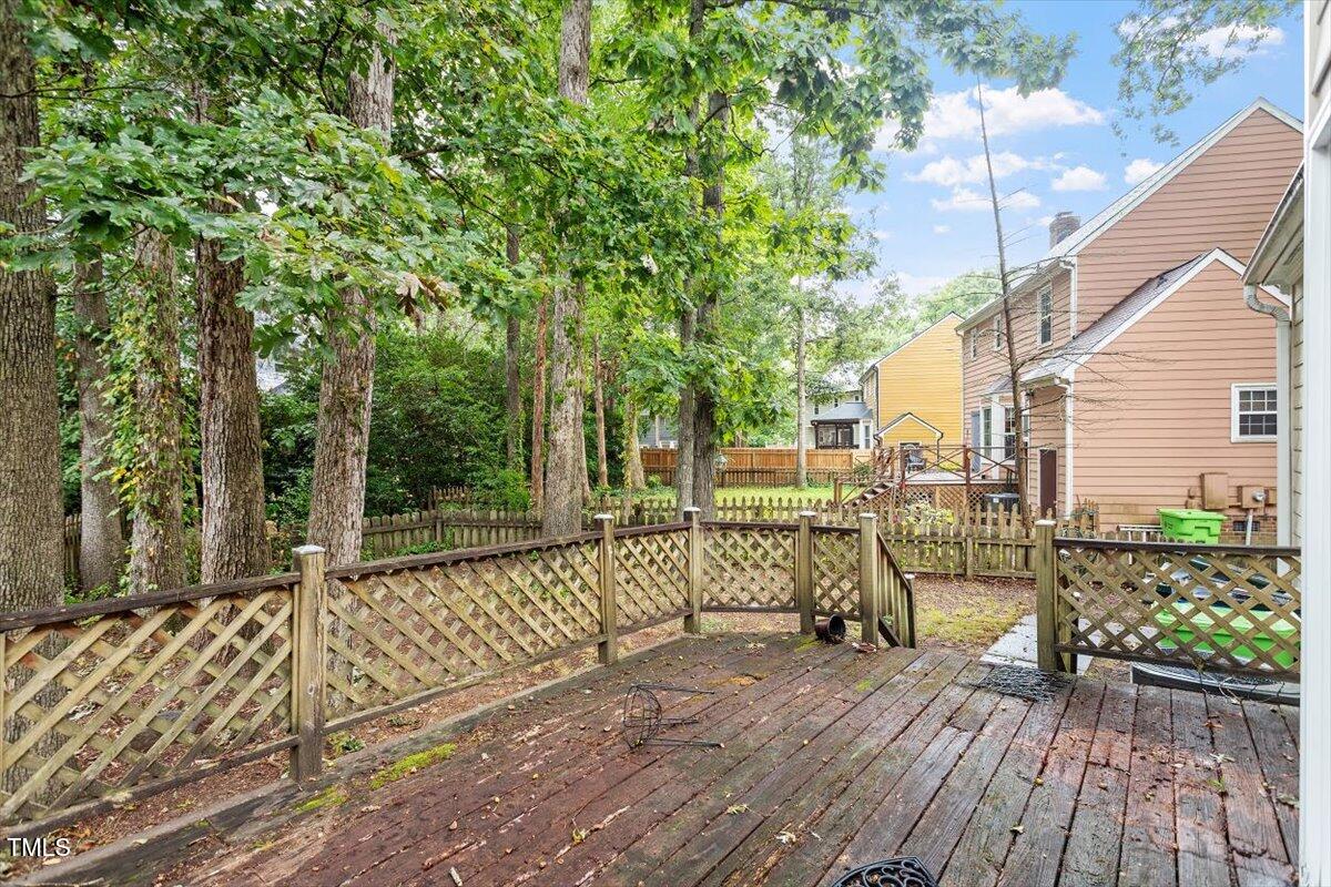 4616 Draper Road Raleigh, NC 27616 - Photo 26 of 34 a view of a deck with wooden floor and bench next to a yard