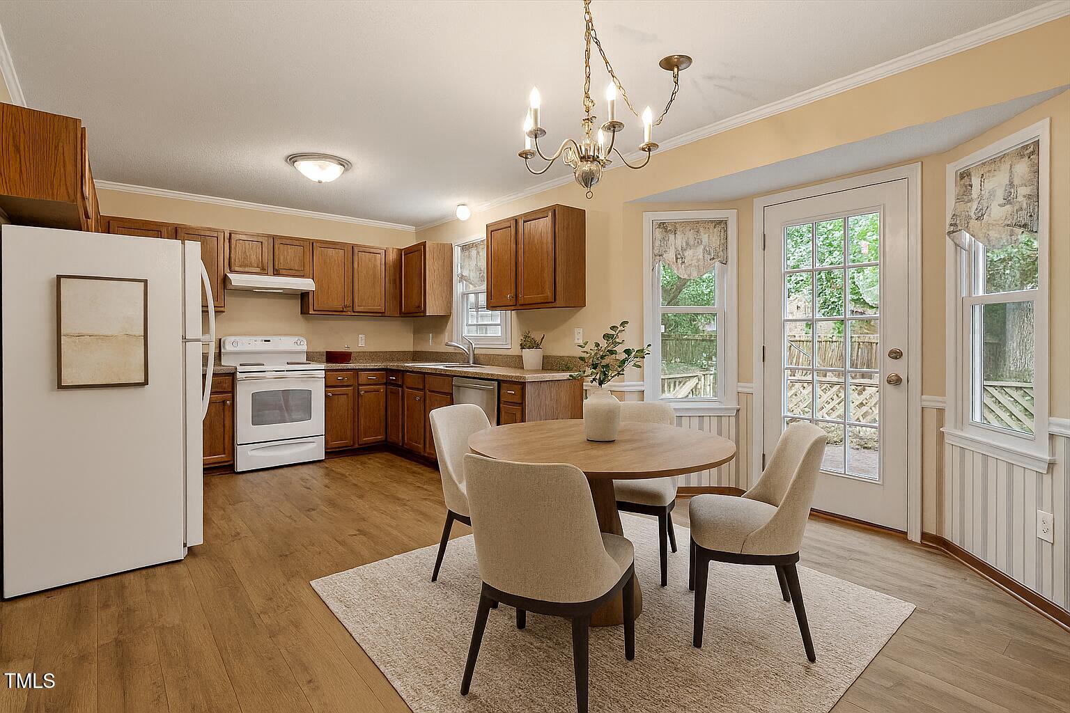 4616 Draper Road Raleigh, NC 27616 - Photo 8 of 34 a dining room with furniture a window and wooden floor