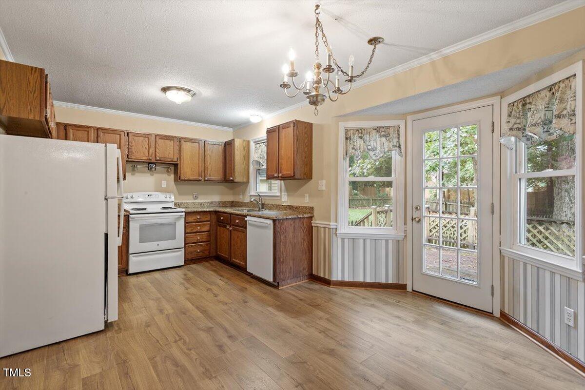 4616 Draper Road Raleigh, NC 27616 - Photo 9 of 34 a kitchen with a stove a sink and a refrigerator