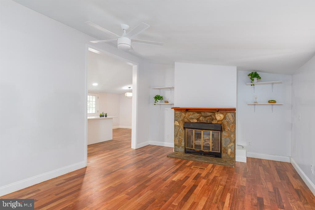 426 7th Street Somers Point, NJ 08244 - Photo 11 of 22 a view of empty room with wooden floor and fireplace