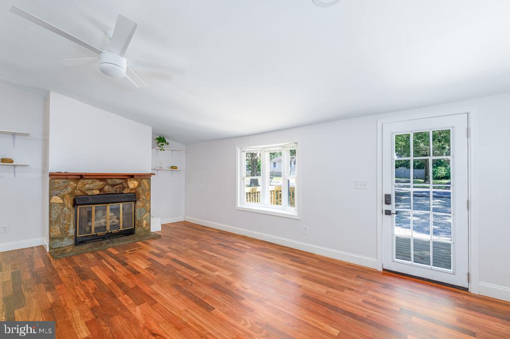 426 7th Street Somers Point, NJ 08244 - Photo 12 of 22 an empty room with windows fireplace and wooden floor
