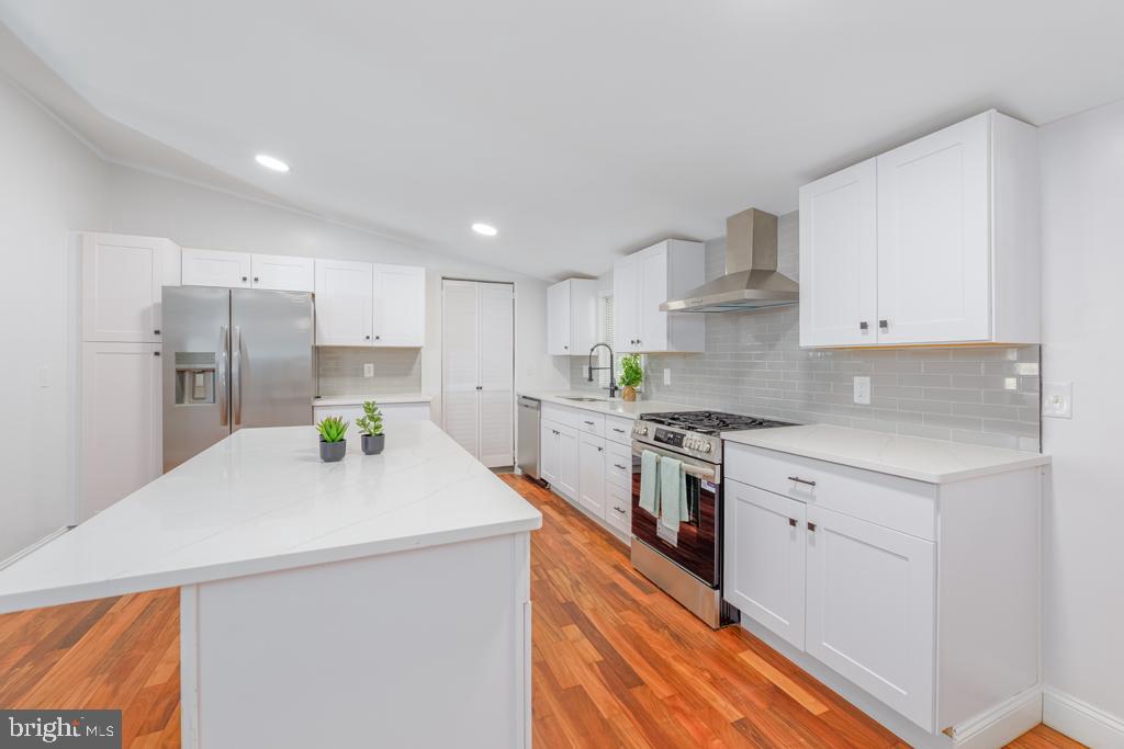 426 7th Street Somers Point, NJ 08244 - Photo 17 of 22 a kitchen with stainless steel appliances a refrigerator sink stove and cabinets