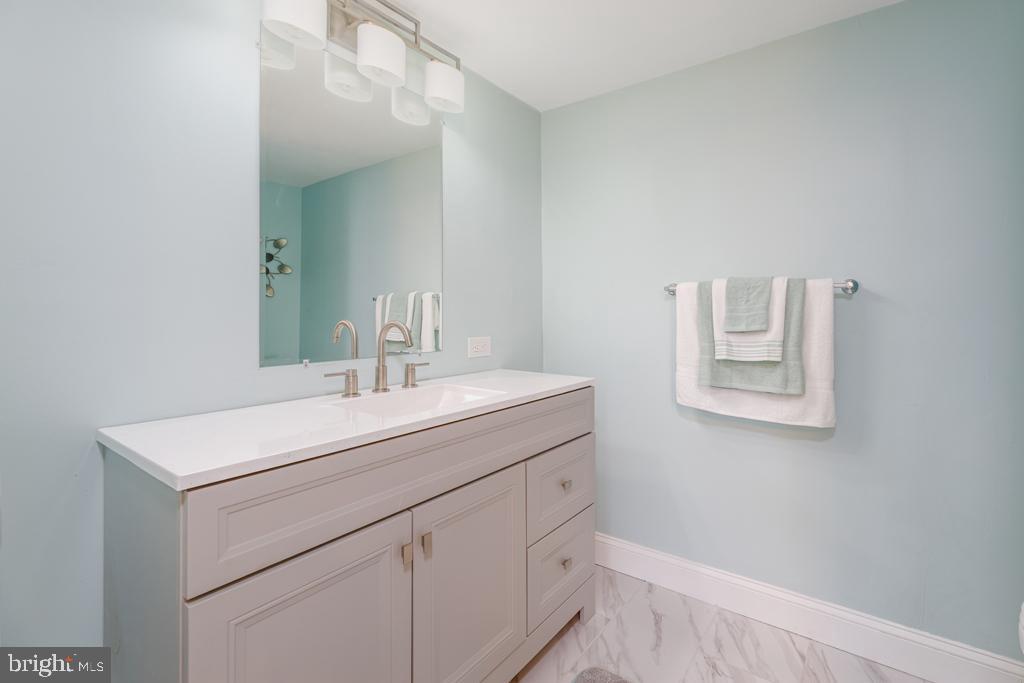 426 7th Street Somers Point, NJ 08244 - Photo 19 of 22 a bathroom with a sink and a mirror