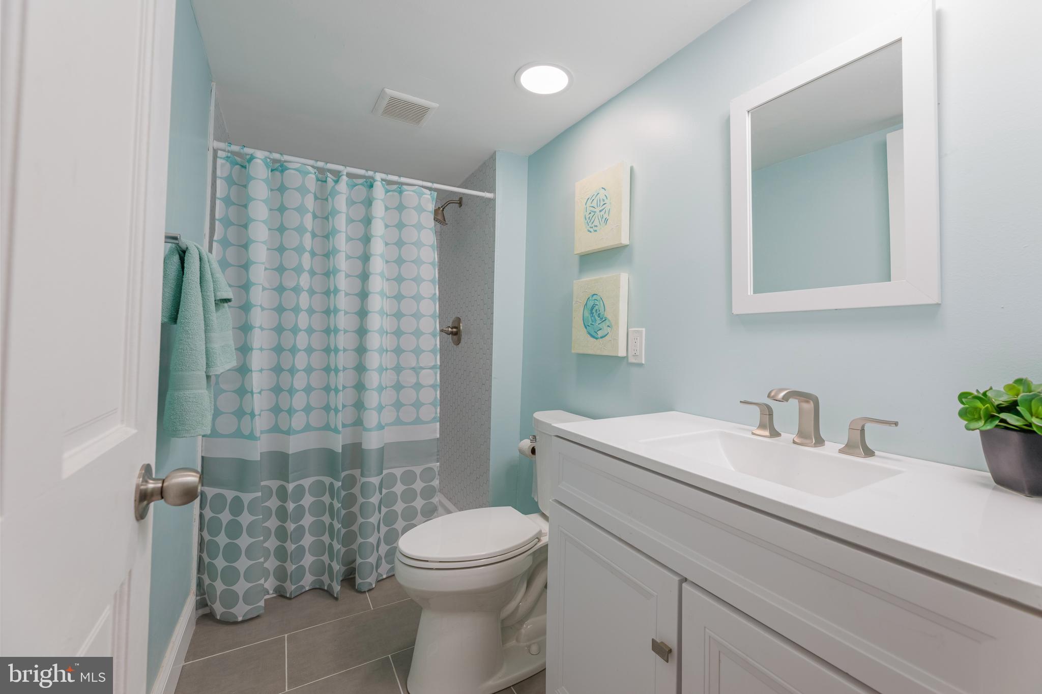 426 7th Street Somers Point, NJ 08244 - Photo 21 of 22 a bathroom with a sink a toilet and shower