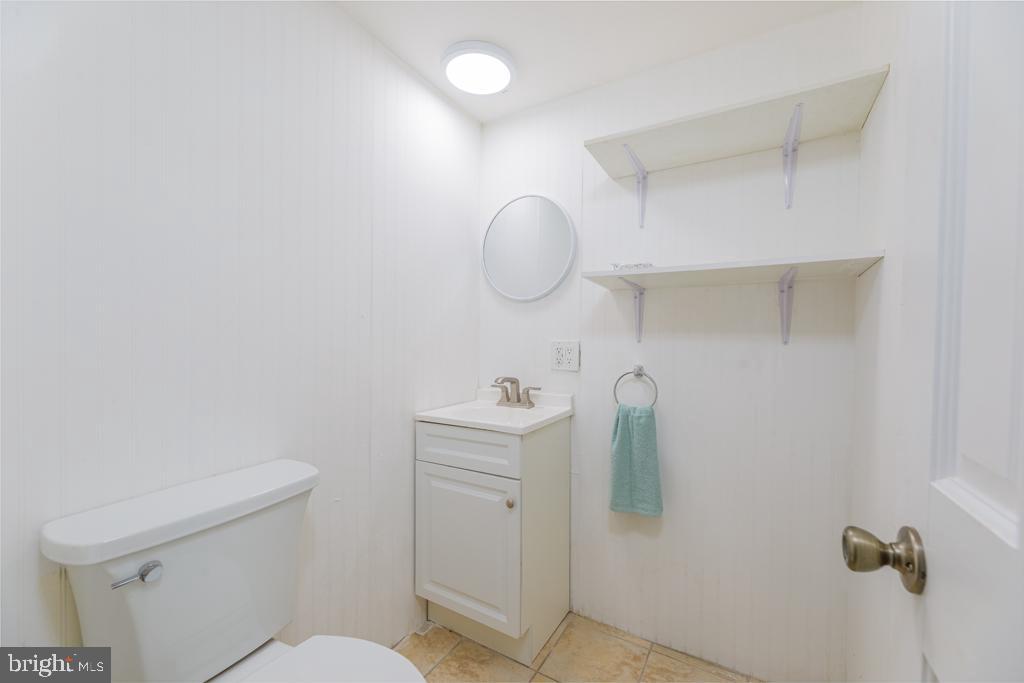 426 7th Street Somers Point, NJ 08244 - Photo 22 of 22 a bathroom with a sink toilet and mirror