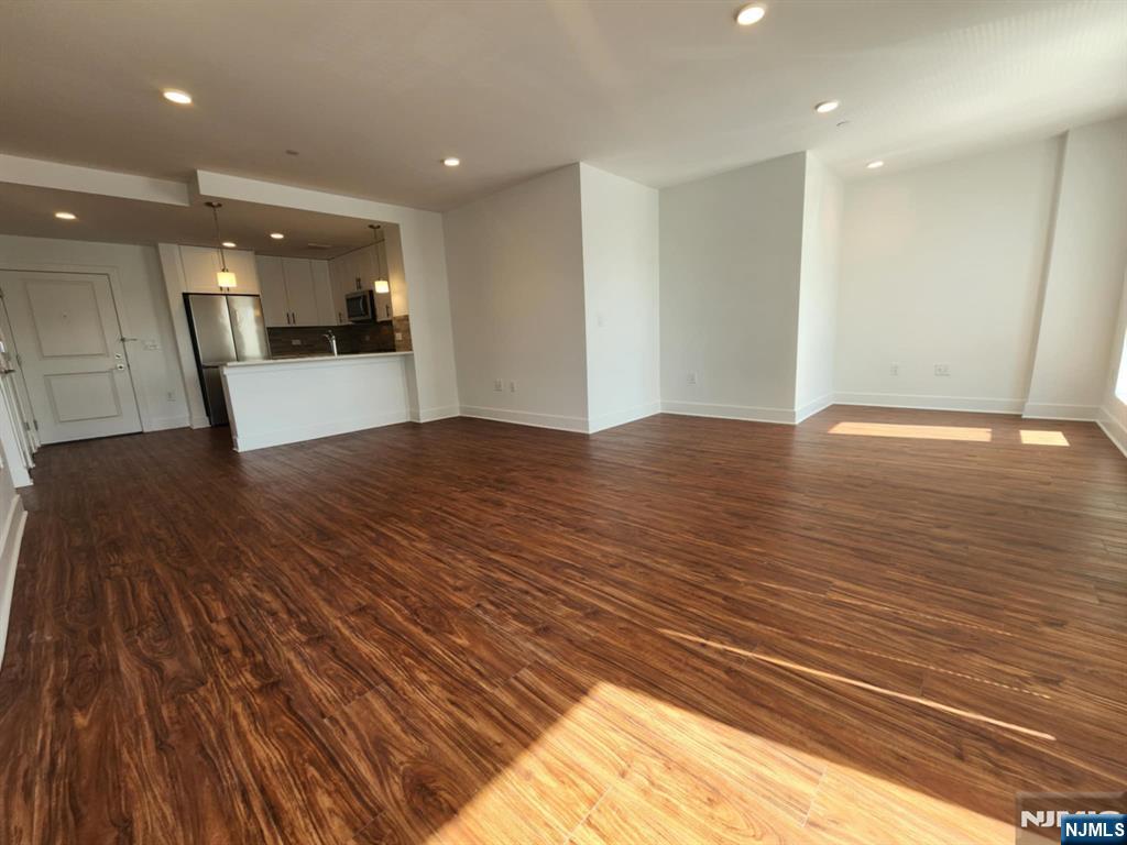 77 Ridge, Unit 108 North Arlington, NJ 07032 - Photo 9 of 24 a view of empty room with wooden floor