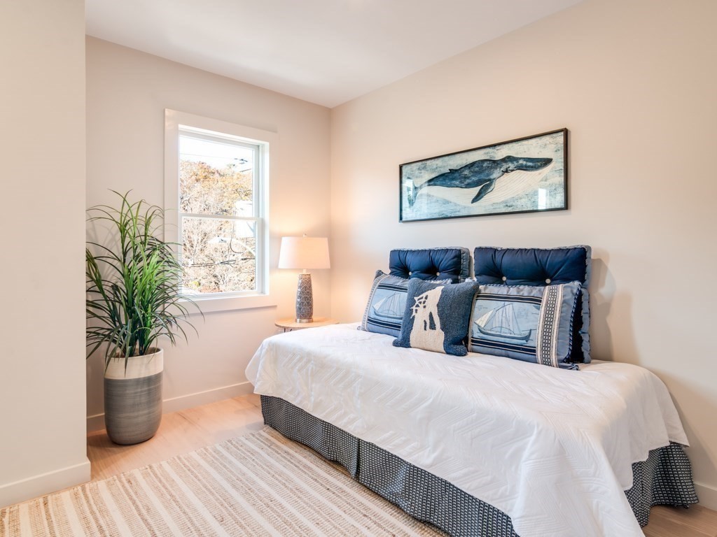 302 Western Avenue, Unit B Gloucester, MA 01930 - Photo 15 of 33 a bedroom with bed and a potted plant