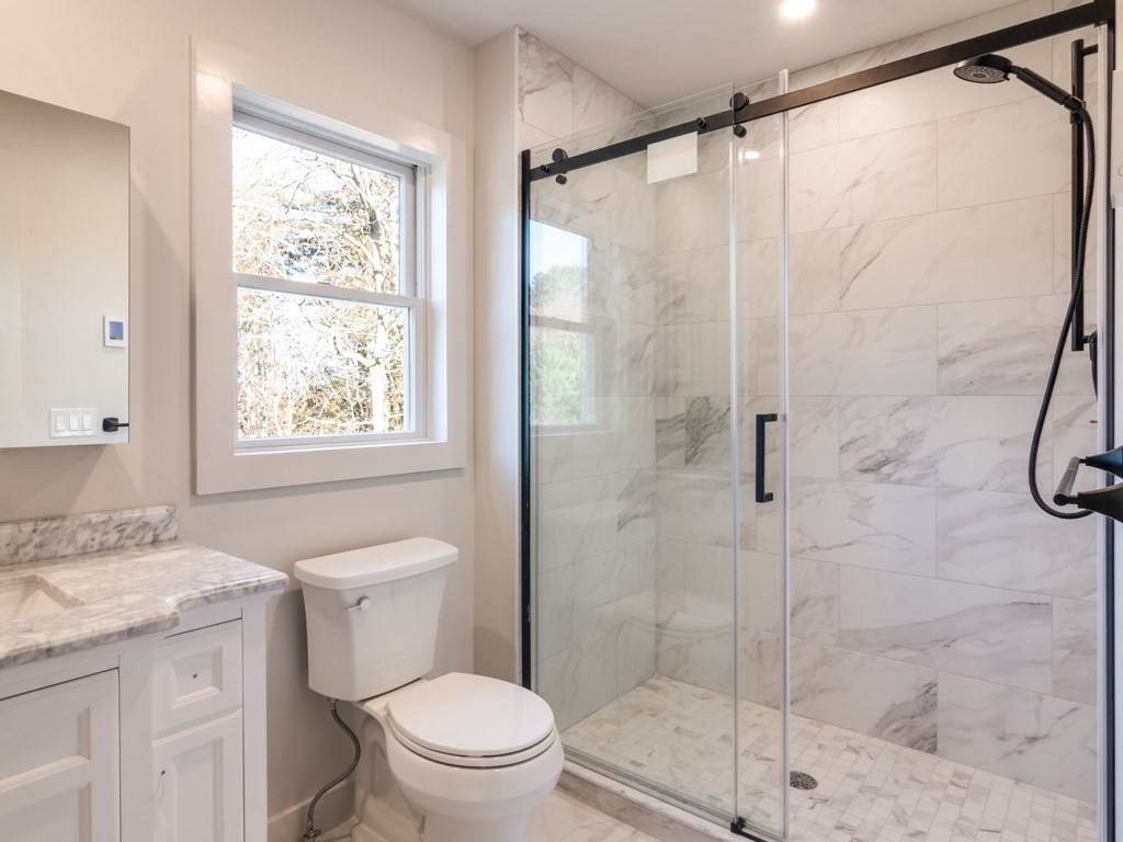 302 Western Avenue, Unit B Gloucester, MA 01930 - Photo 17 of 33 a bathroom with a granite countertop sink a toilet and shower