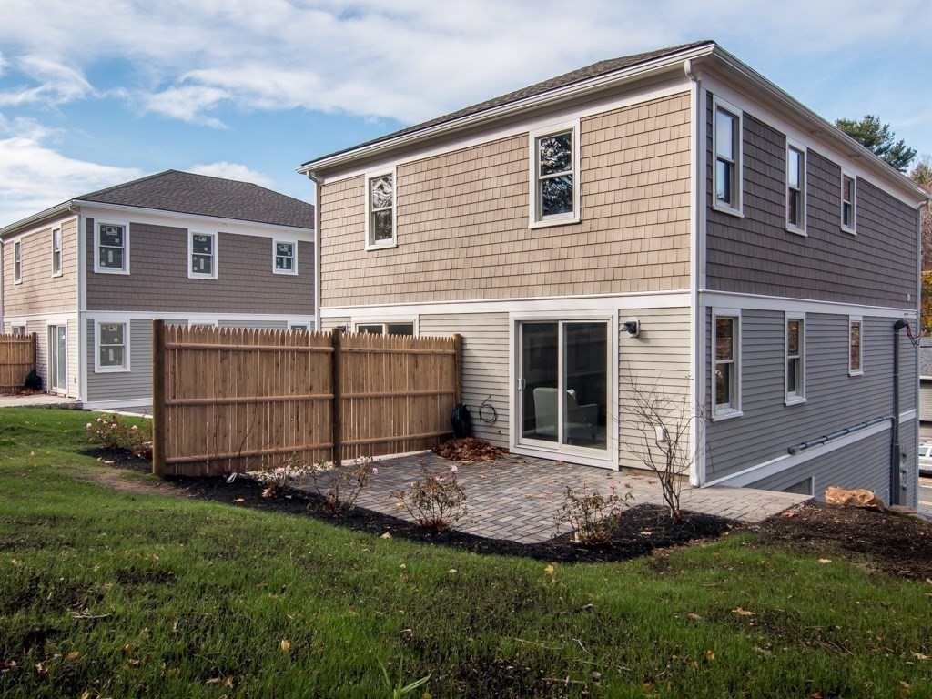 302 Western Avenue, Unit B Gloucester, MA 01930 - Photo 25 of 33 a view of a backyard with potted plants and a large tree