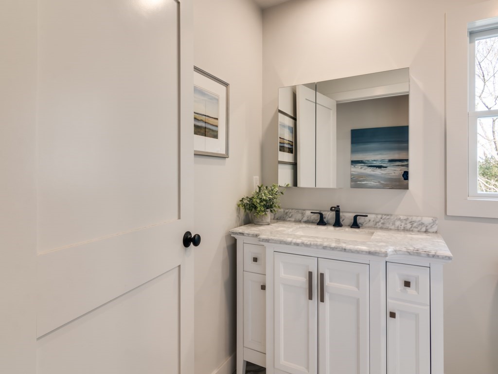 302 Western Avenue, Unit B Gloucester, MA 01930 - Photo 32 of 33 a bathroom with a granite countertop sink vanity and mirror