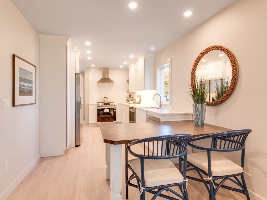 302 Western Avenue, Unit B Gloucester, MA 01930 - Photo 9 of 33 a view of a dining room with furniture and a mirror