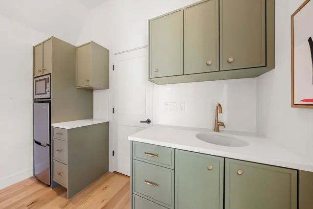 a kitchen with stainless steel appliances white cabinets and a sink