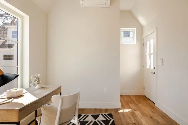 a view of a room with furniture and wooden floor