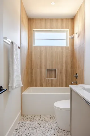 a bathroom with a bathtub a toilet and a shower