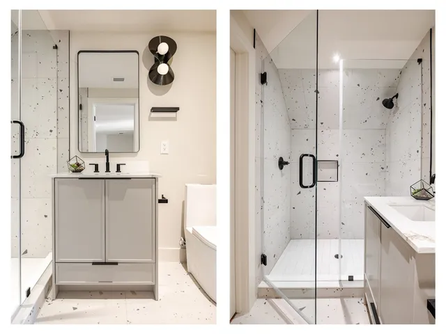 a bathroom with a double vanity sink mirror and shower