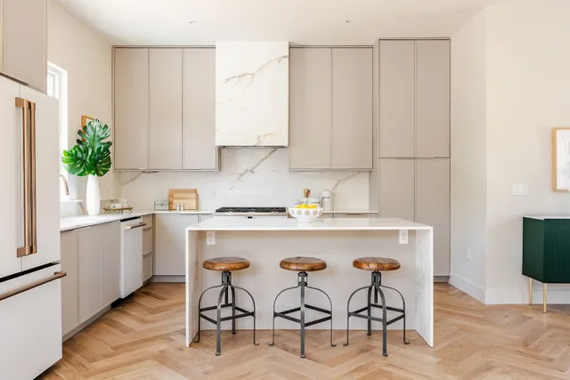 a kitchen with a white cabinets and chairs
