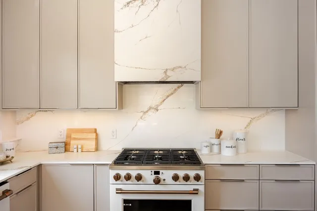 a kitchen with granite countertop a stove and a sink