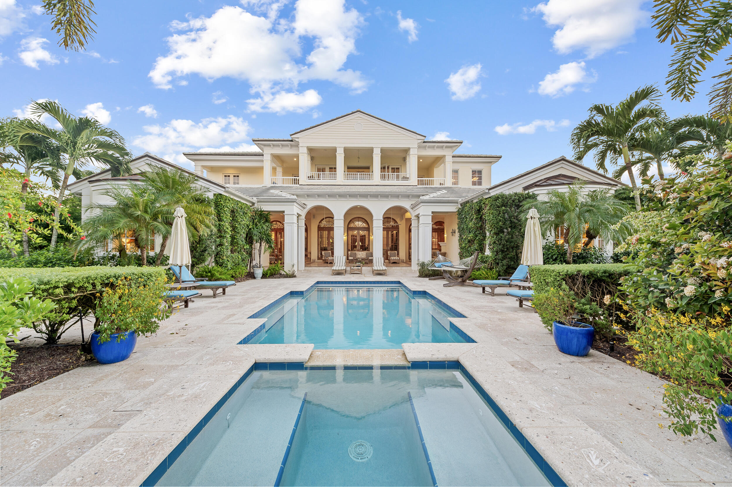 6968 Southeast Harbor Circle Stuart, FL 34996 - Photo 1 of 40 a front view of a house with a yard