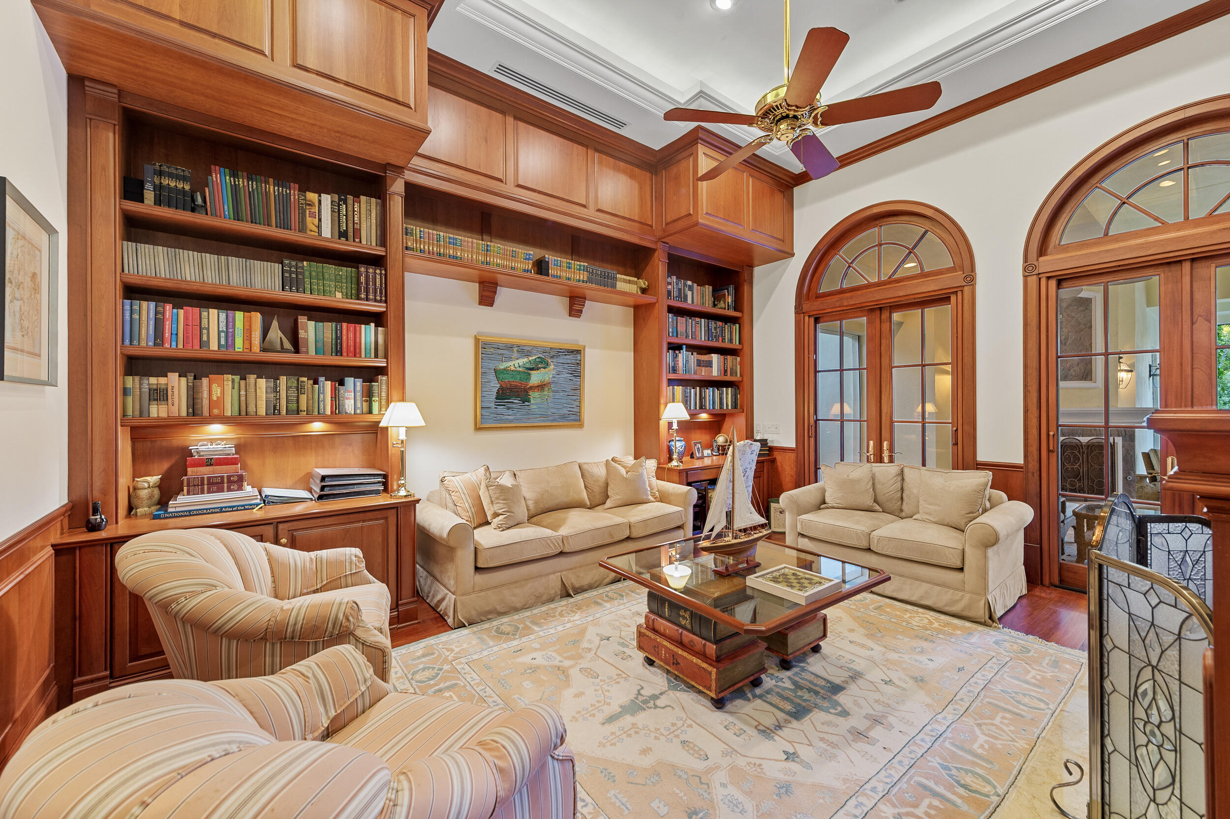6968 Southeast Harbor Circle Stuart, FL 34996 - Photo 11 of 40 a living room with furniture a bookshelf and a large window