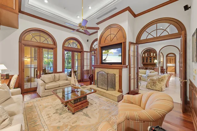 a living room with furniture a large window and a clock