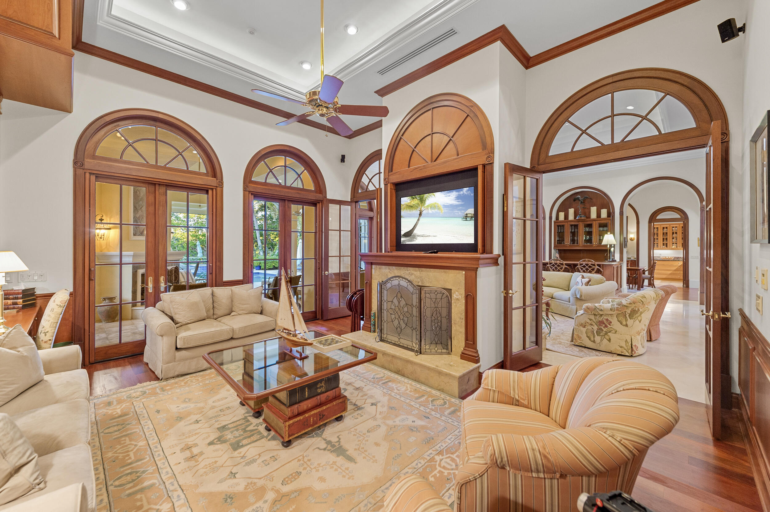6968 Southeast Harbor Circle Stuart, FL 34996 - Photo 12 of 40 a living room with furniture a large window and a clock