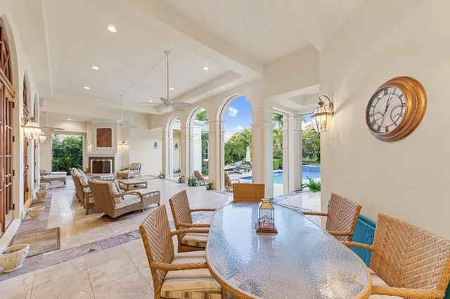 a living room with furniture a clock and a large window