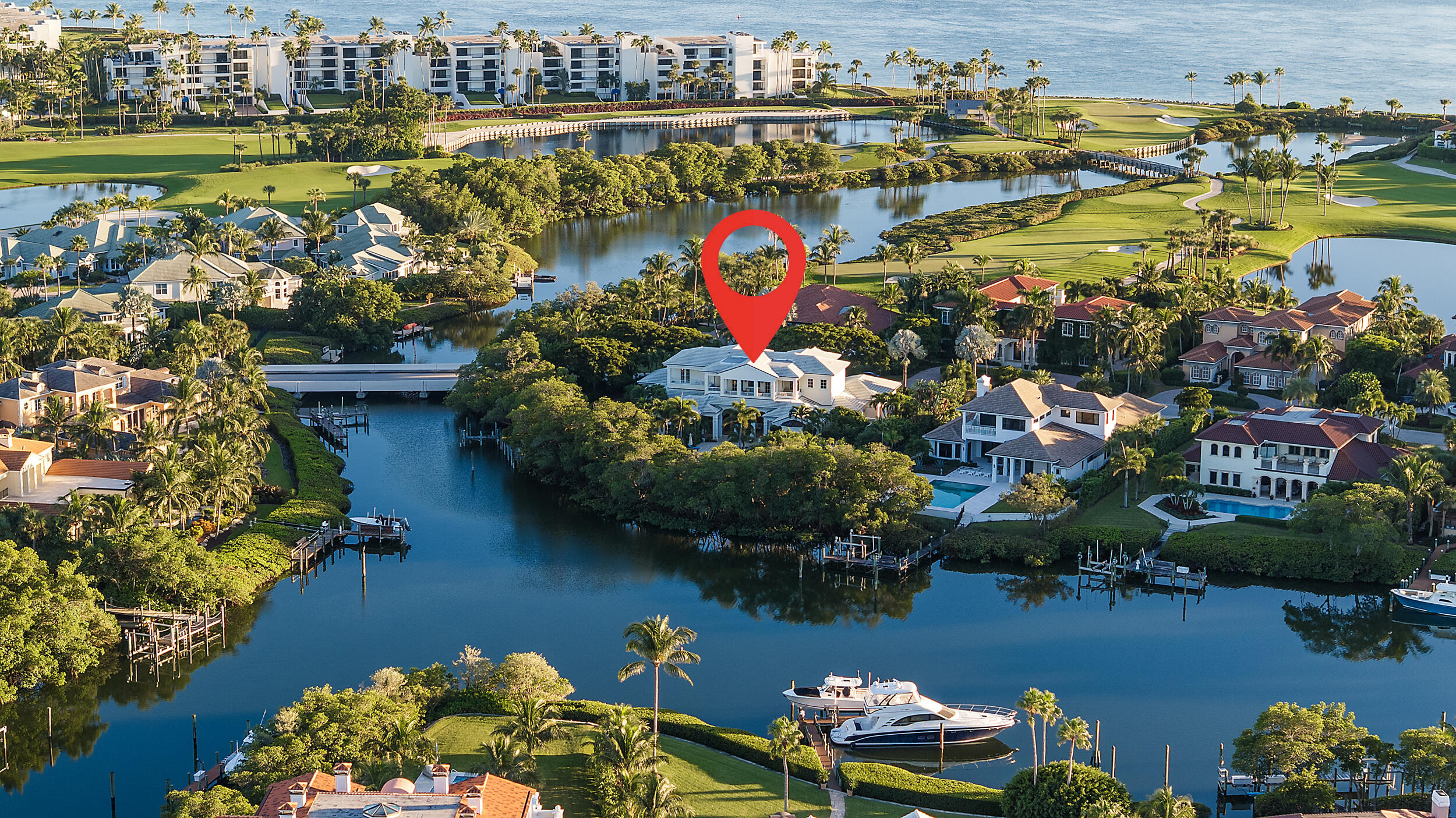 6968 Southeast Harbor Circle Stuart, FL 34996 - Photo 2 of 40 an aerial view of a house with a lake boats and trees all around