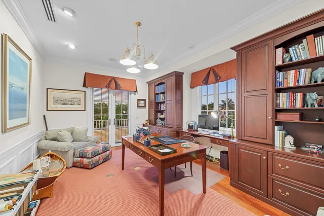 a living room with furniture and a book shelf