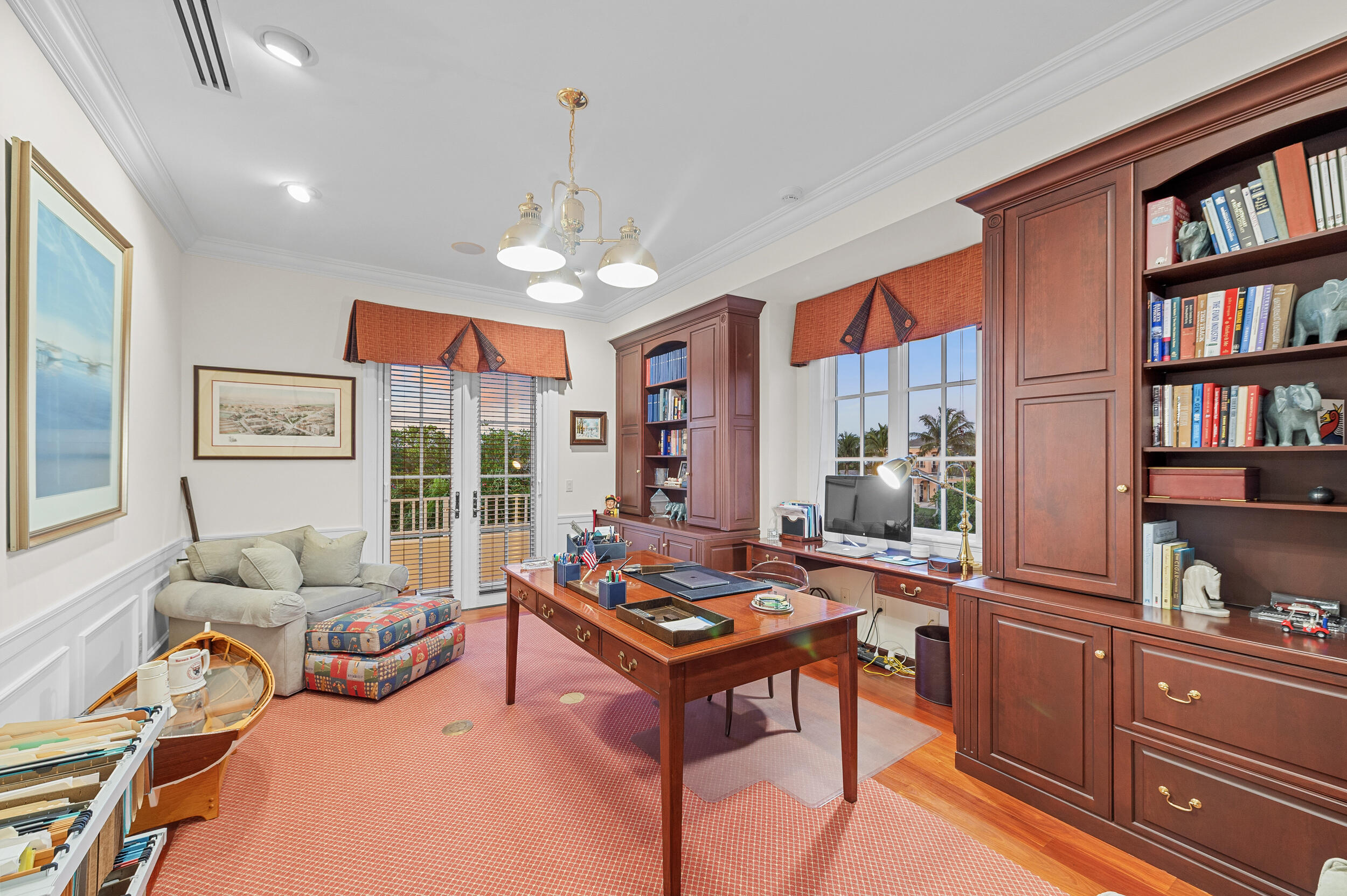 6968 Southeast Harbor Circle Stuart, FL 34996 - Photo 22 of 40 a living room with furniture and a book shelf