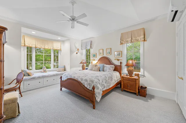 a spacious bedroom with a bed and a table lamp