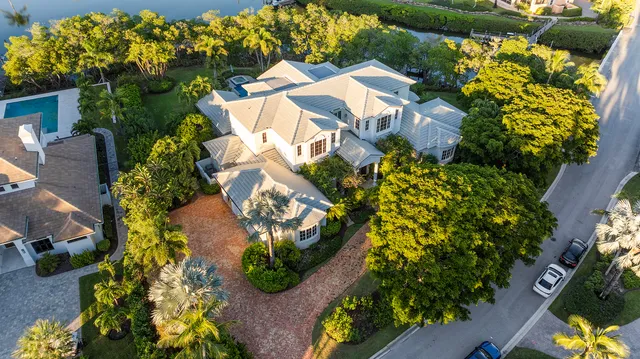 an aerial view of a house with a yard and garden