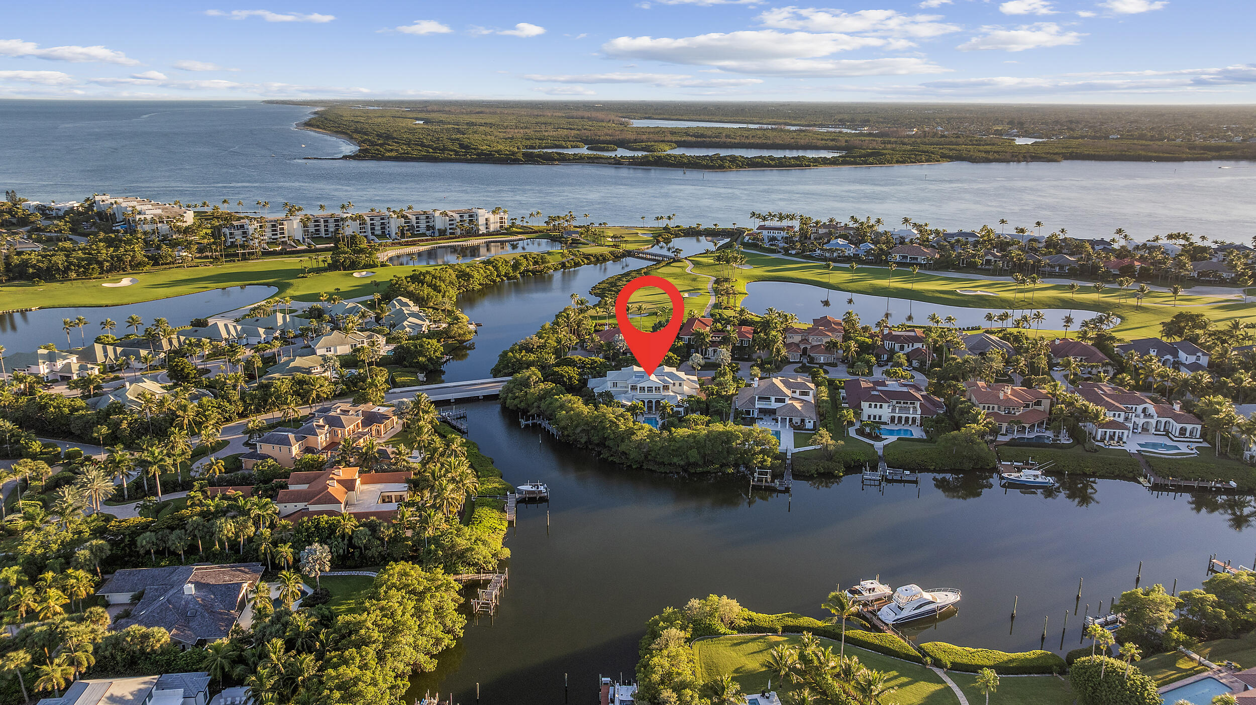 6968 Southeast Harbor Circle Stuart, FL 34996 - Photo 38 of 40 a view of a lake with a building in the background