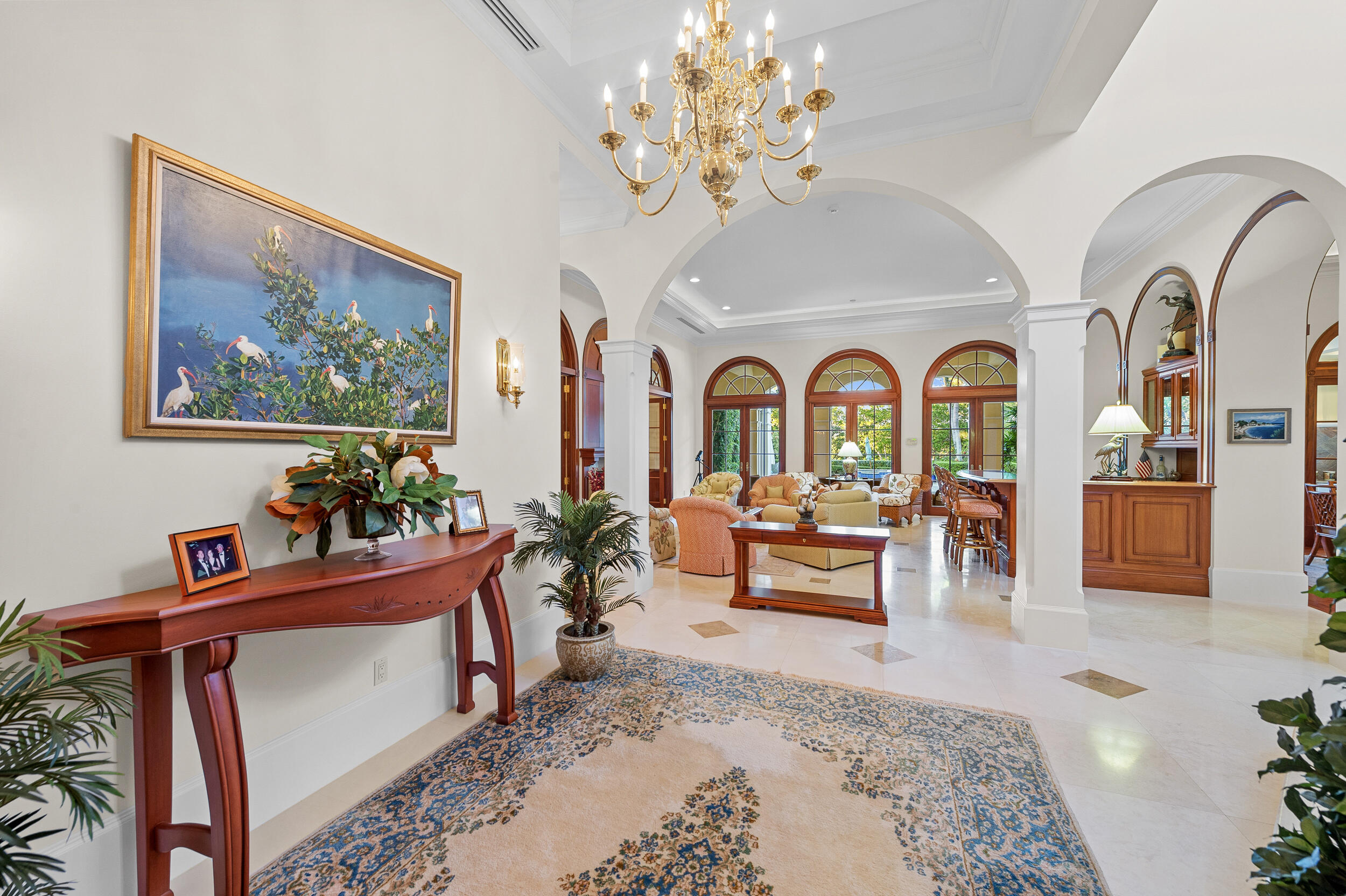 6968 Southeast Harbor Circle Stuart, FL 34996 - Photo 7 of 40 a living room with furniture piano and a chandelier
