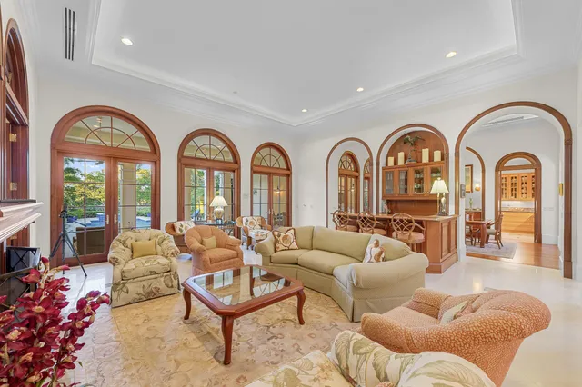 a living room with furniture fireplace and a large window