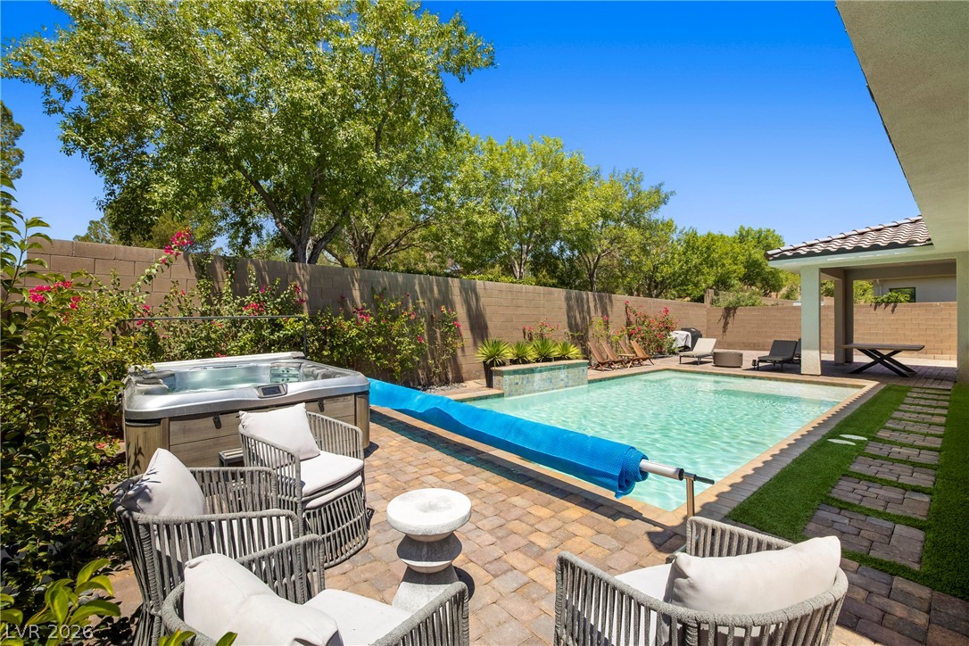 45 Garibaldi Way Henderson, NV 89011 - Photo 37 of 74 An inviting backyard oasis offers a sparkling pool and spa, perfect for relaxation and entertainment.