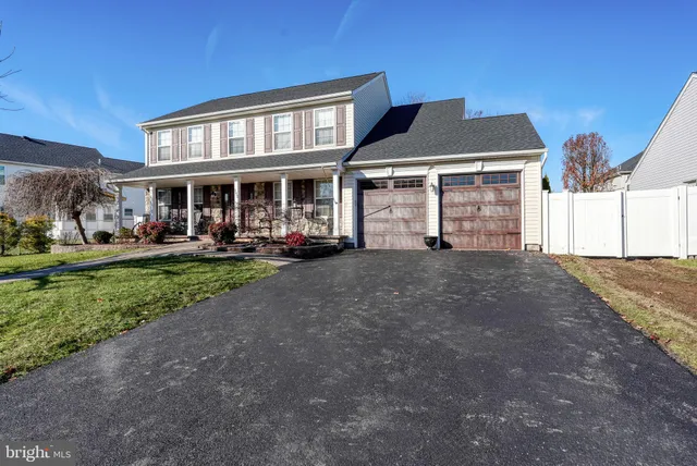 a front view of a residential apartment building with a yard